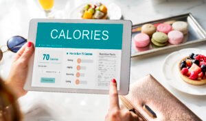 Tracking calories and nutrition on a tablet as part of a personalized weight loss program in Pearland, promoting a healthy weight loss plan for lasting results.